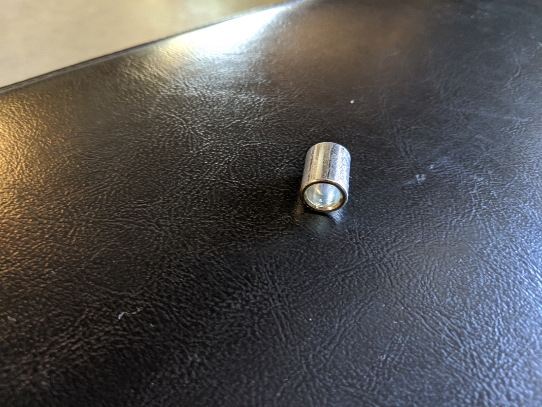 E95 Step 2-4 01 Required Spacer (24) found on floor, from rod end of left lower handle bar arm.jpg