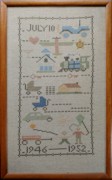 1952-12~ 2 Diane's cross-stitch sampler, now with Morgan.jpg