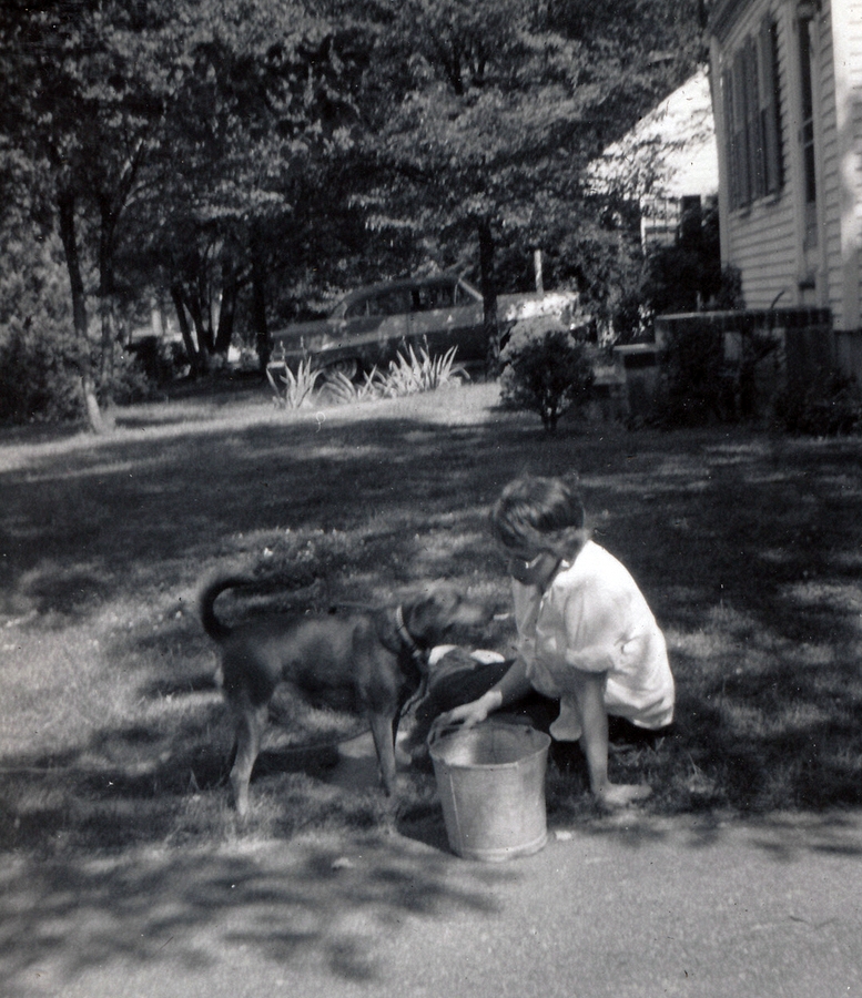 1957-05-18 1 Diane weeding the walk, with Dusty; Armed Forces Day.jpg