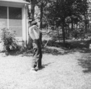 1961-08-01~ 2 Pete Jr practicing archery in back yard, 26 Driftwood Ln, Weston MA.jpg